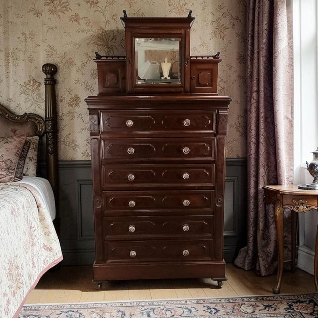 Tall chest with mirror by Kimbel & Cabus, New York, circa 1865–1880. Executed in walnut, this example reflects the firm’s...
