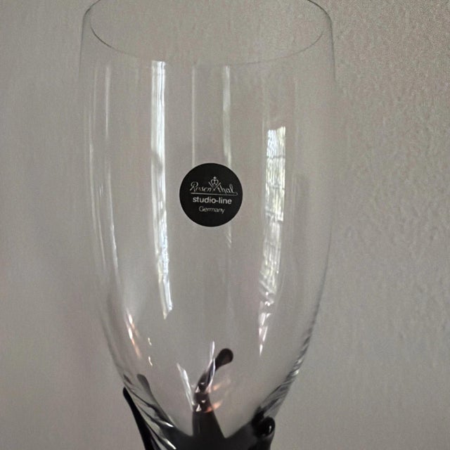 The product is a pair of vintage Rosenthal Studio Line champagne flutes in the Black Crown pattern. These elegant German...