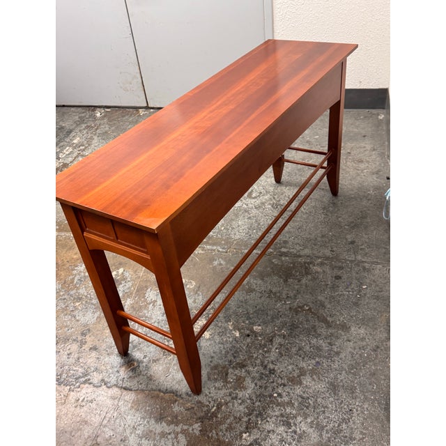 Design Plus Gallery presents a Sofa Table by Impressions for Thomasville Bridges Collection. The sofa table is long and...