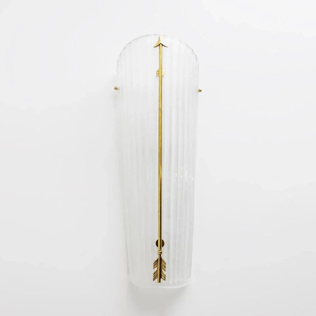 Pair of frosted white glass wall lights with a brass arrow running the length, brass screws holding the glass to the sides...