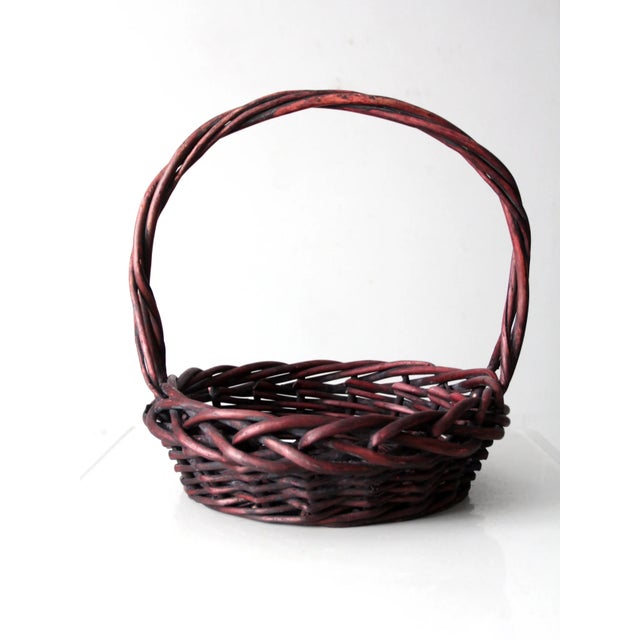This vintage woven wood basket in a rich burgundy tone adds warmth and rustic charm to any home. Its tightly woven...