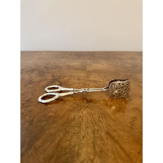 Fine quality pair of antique silver serving tongs, having a quality pair of antique silver serving tongs with rounded...