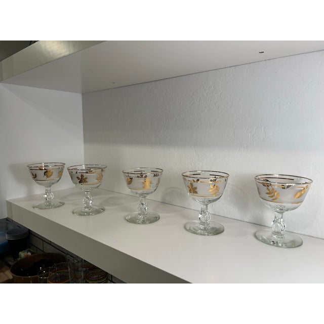 Set of five champagne coupes in the iconic Golden Foliage pattern by Libbey glass company. Height: 4 1/2in Width: 3 1/2 in...