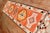 Mid 20th century tribal Turkish Anatolian runner with a tribal design in brown, orange, pink, and ivory dominant accents...