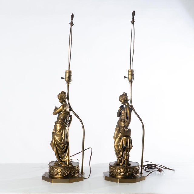 Pair of classical form figural lamps. This excellently detailed pair of lamps brings a beautiful decor to any room.