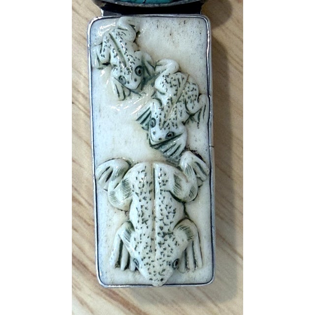 Amy Kahn Russell Artisan Pendant Set in sterling silver, the top portion is a rectangular hand-carved bovine bone segment...