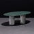 Dining table with green Serpentino marble top and multifaceted pedestals in cast aluminum. Inspired by Doric columns in...