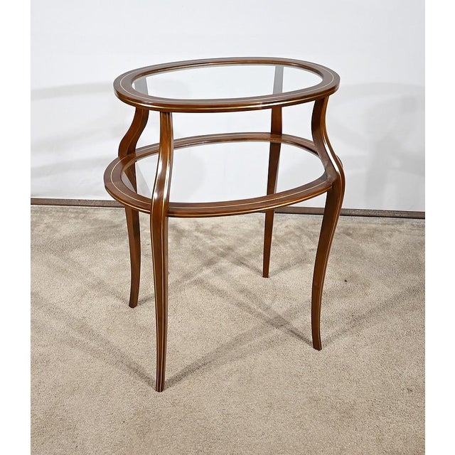 Service table with an oblong shape top, made up of four solid mahogany elements. The inner part is slightly in the quarter...