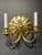 A pair of sunburst shaped backplate sconces with 2 lights