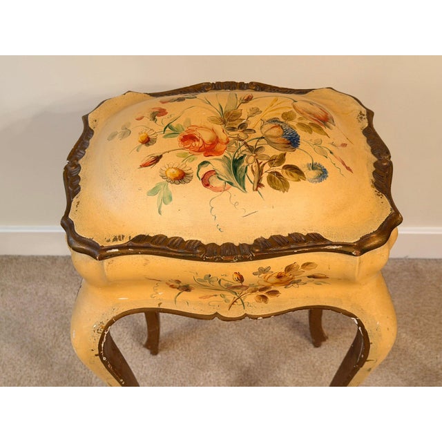 Finished in a warm mustard-yellow ground, the piece is decorated by hand with colorful floral bouquets, scrolling accents...