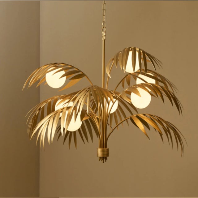 The Palm Chandelier brings tropical elegance into any space with its intricately hand-molded palm leaf silhouette, casting...