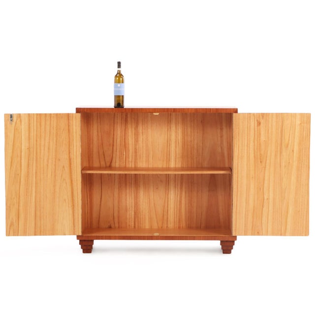 A beautiful contemporary cabinet in the manner of Jean-Michel Frank. This Art Deco-inspired wooden cabinet features a...