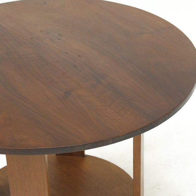 A decoratively shaped Art Deco side table from the 1930s with an elegant base. The table is crafted from solid oak with a...