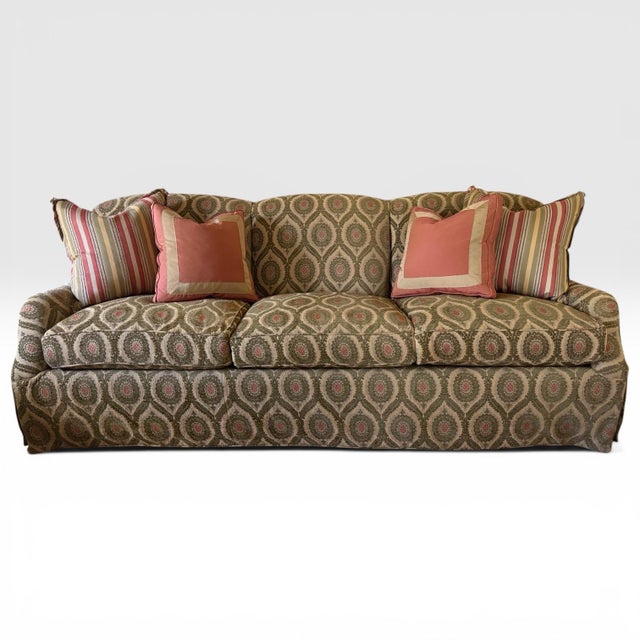 A beautiful roll arm sofa from luxury furniture maker A. Rudin. Upholstered in a striking fabric with embroidered sage...