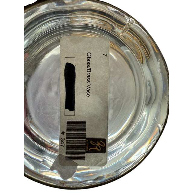 John-Richard Glass and Brass Vase This violin shaped glass vase by John-Richard offers traditional accents. It stands on a...