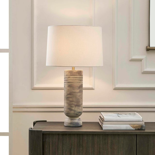 The Vale Table Lamp Boasts A Unique Ceramic Base With Horizontal Grooves, Finished In A Subtle Gray Wash With Warm Beige...