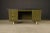 A classic American mid-century modern steel tanker desk, circa 1960s, featuring a olive green finish and custom protective...