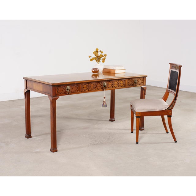 Stately Georgian chippendale style writing table or desk crafted by Baker Furniture. The desk is constructed from mahogany...