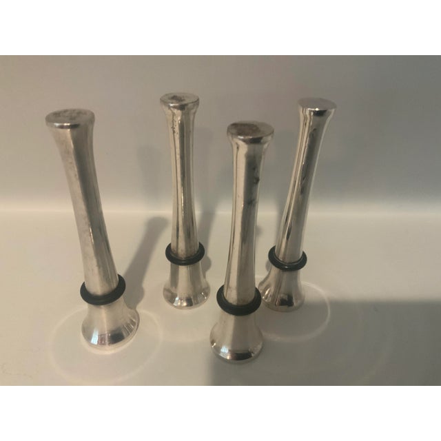 For the wine enthusiast-Set of 4 silver plate wine/bottle stoppers and a champagne pliers. . A lovely addition to your bar...