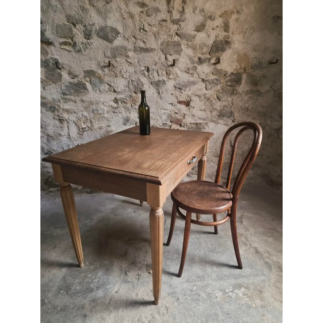 Vintage French writing desk with bistro chair, dating from circa 1930. The table is made from oak with elm legs. It has a...