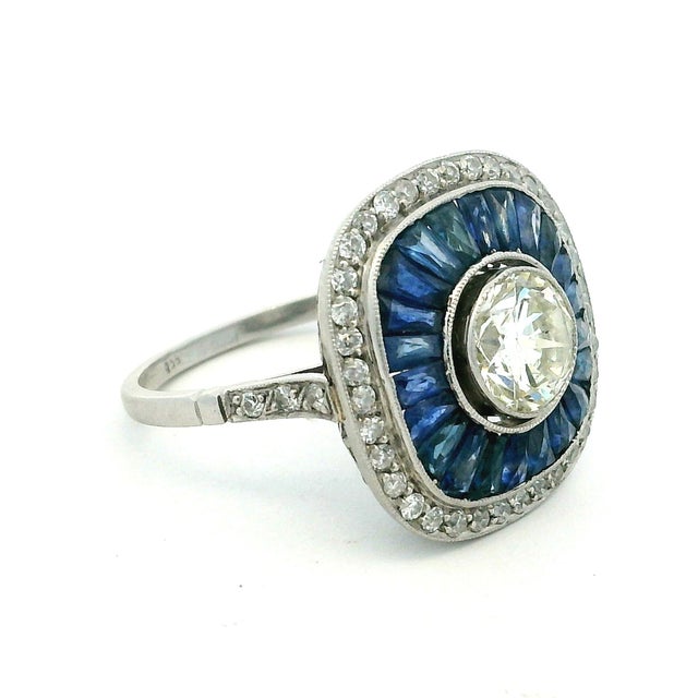 A sophisticated circa-1930 Art Deco target ring handcrafted in platinum and centered by an approximately 1.00-carat round...
