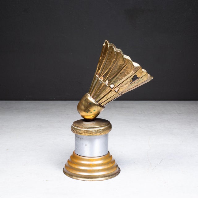 ABOUT A vintage brass badminton trophy. Inscribed "All City Mixed Doubles Ida Lord 1947". CREATOR Dodge Inc. DATE OF...