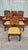 1960's set of six dining chairs constructed from solid wood with a warm brown finish. Each chair has a curved wooden...