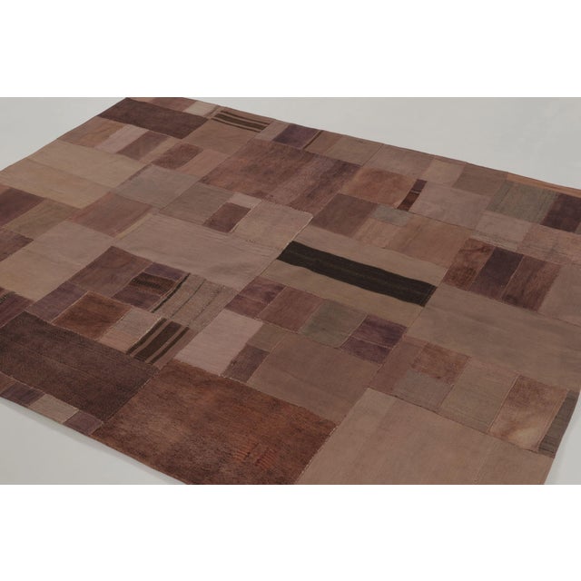 Handwoven in cotton and wool, this 6x8 vintage Turkish patchwork rug, dating to circa 1950–1960, reflects the enduring...