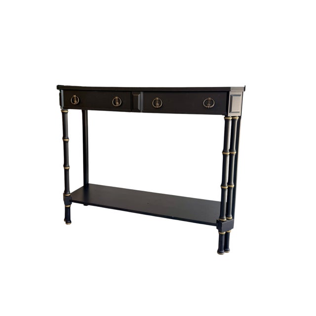 A timeless blend of classic and Hollywood Regency style, this faux bamboo console table in a satin black finish with...