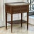 A finely crafted French Louis XVI style end table in solid mahogany, crowned with beautifully veined Carrara marble and...