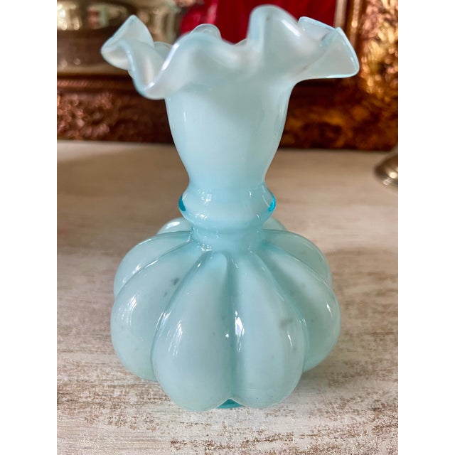 This sweet Vintage Fenton Light Blue Melon Vase With Ruffled Edge is the perfect detail to add to any room.