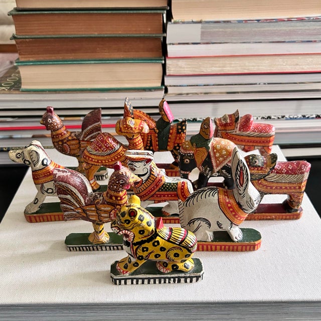 A rare assembled set of 11 antique Indian folk-art figures, individually carved and hand-painted in saturated red,...
