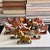 A rare assembled set of 11 antique Indian folk-art figures, individually carved and hand-painted in saturated red,...