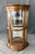 This Pulaski Furniture Co. bombe front curio cabinet features a gracefully curved silhouette with wraparound glass panels,...