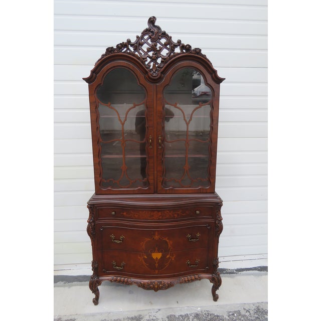 This brilliant China Cabinet is made of wood, solid wood, walnut, veneer, and glass. This gorgeous cabinet is labeled as...