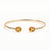 Add a touch of timeless elegance to your jewelry collection with this beautifully crafted Oval Citrine Open Cuff Bracelet....