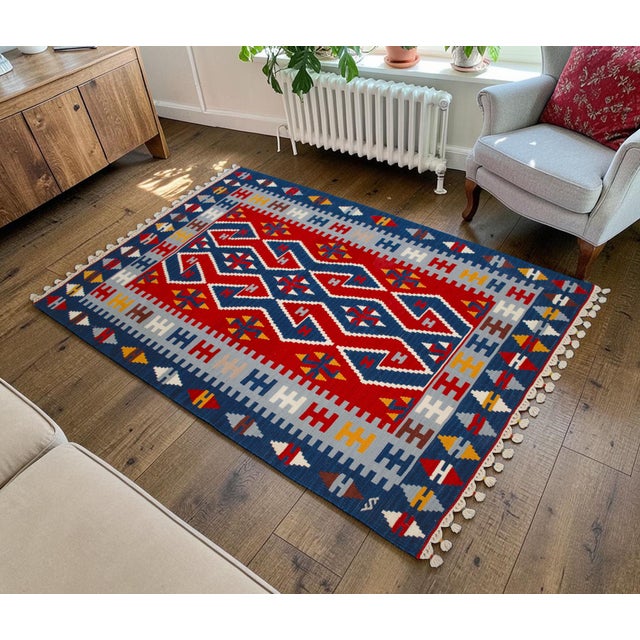 Woven in the prestigious region of Oushak during the 1980s, this vintage flat weave kilim showcases the enduring appeal of...