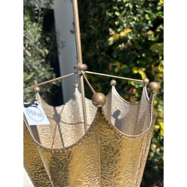 Vintage solid brass umbrella stand featuring beautifully embossed panels with ornate scrolling and floral motifs...