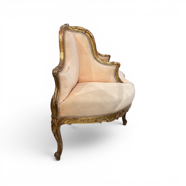 A 19th century Swedish three seat banquette featuring a beautifully carved giltwood frame with graceful, flowing lines and...