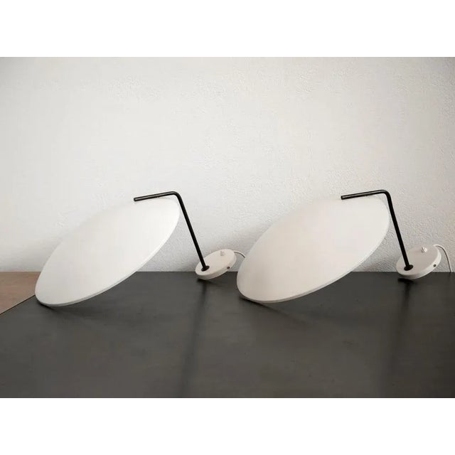 A pair of 'Model 232' wall lamps by Bruno Gatta for Stilnovo, Italy 1960s. The large bowl-shaped shades are supported by a...