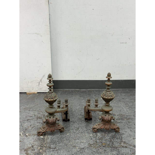 Design Plus Gallery presents a Pair of Antique Fireplace Andirons. Each piece has an anchored sculptural, acanthus...