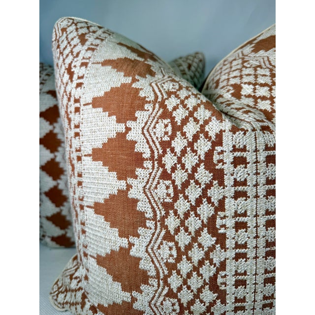 Custom pair of 22" pillows covered in Schumacher "Wentworth Embroidery" in rust and backed in a coordinating rust linen....
