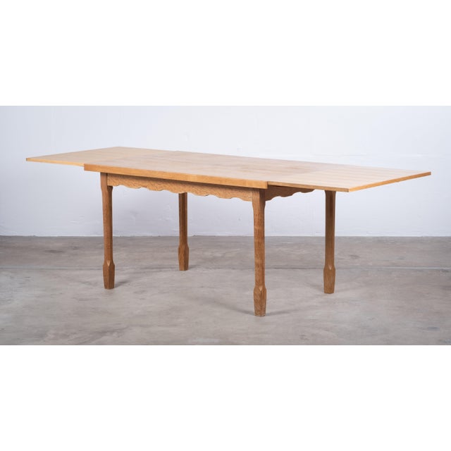 Striking rectangular brutalist dining table in oak, attributed to Henning Kjærnulf and produced in the 1960s. Featuring a...