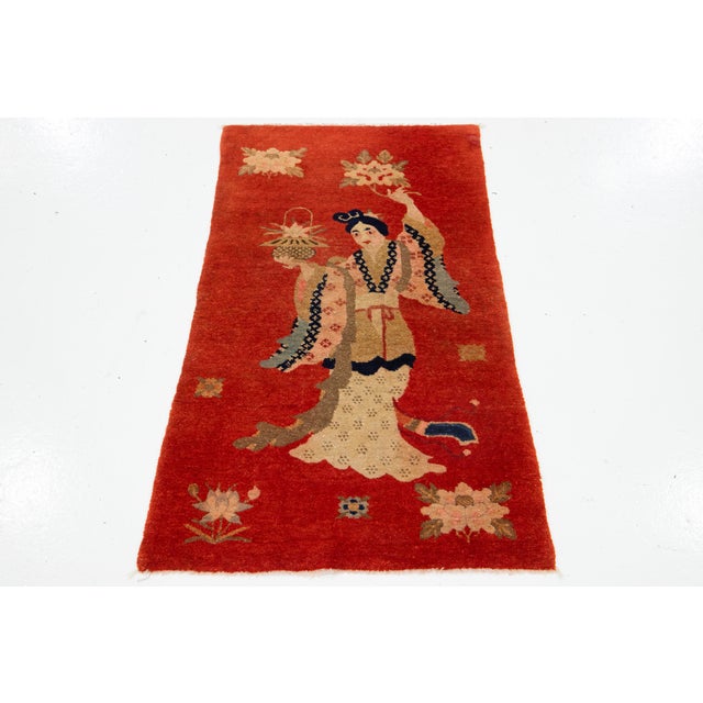 An Antique Chinese Art Deco rug, hand-knotted from wool with a red background. It features a multicolor pictorial design....