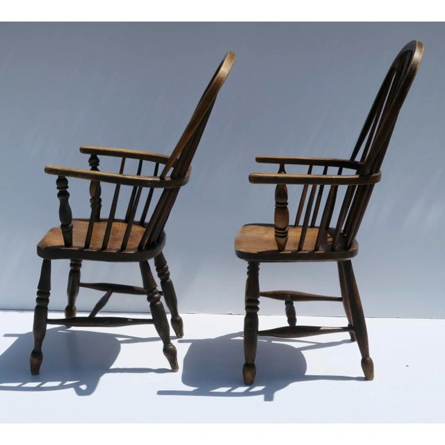 Pair of ash and elm English Windsor chairs with tall backs, pierced back splat and H shaped stretcher. Measure 40 1/2"...