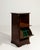This side cabinet makes its impression through dark mahogany, drop-front door, green interior. The piece dates to 19th...