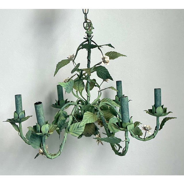 This enchanting vintage Hollywood Regency toleware chandelier is a masterful celebration of garden-inspired design....