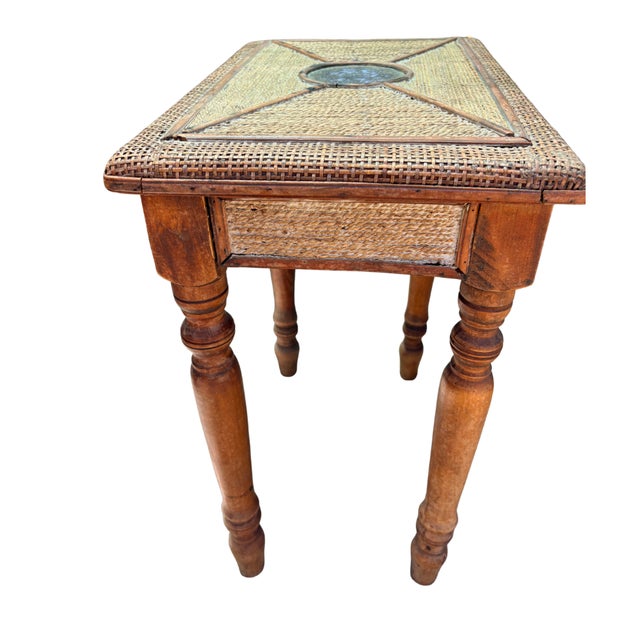 A beautifully crafted vintage side table combining a woven rattan top with a geometric inlay pattern and a central...