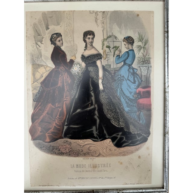 Original hand-colored French fashion plate from La Mode Illustrée, published in Paris in 1869 (No. 3). This elegant...