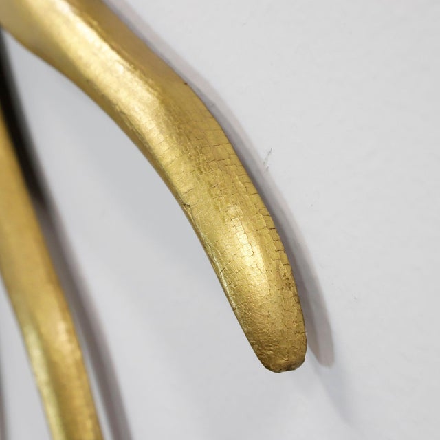 Circa 1960. We offer this antique Mexican sunburst mirror, hand-carved from solid wood and finished with gold leaf. The...